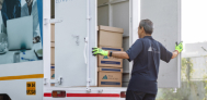 IM employee looking at back of IM truck
