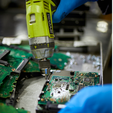 closeup of IM worker disassembling IT assets