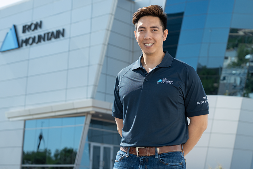 IM employee with a cart of IM boxes in warehouse