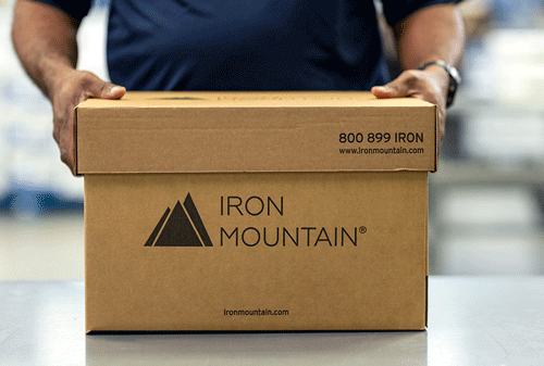 IM employee placing down IM box on tabletop