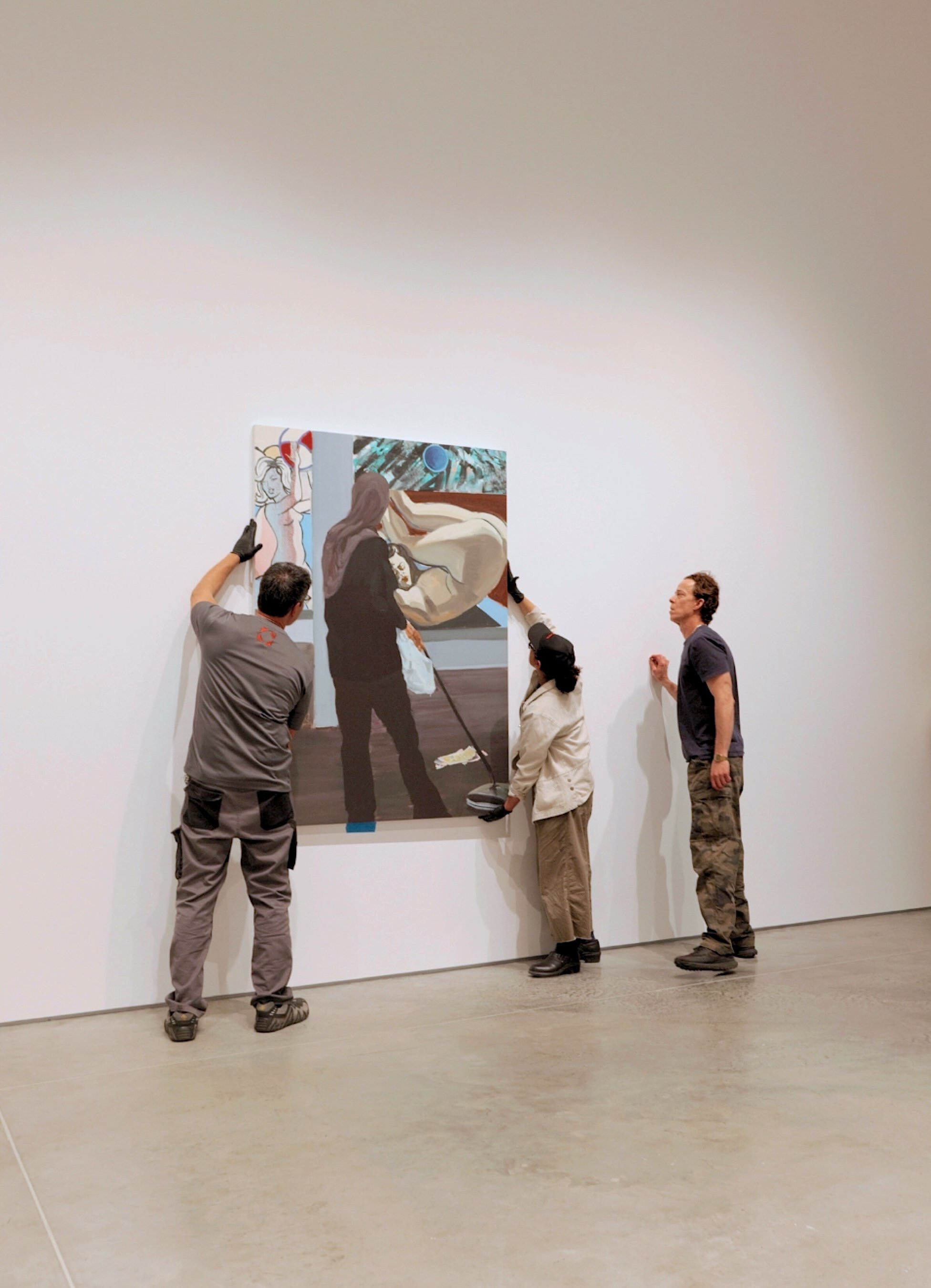 Crozier handlers installing painting on the wall
