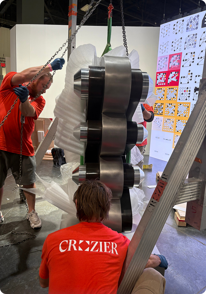 Technicians installing sculpture