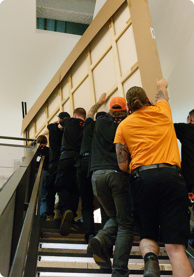 Technicians moving art piece