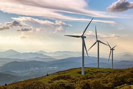windmills with mountain range backdrop