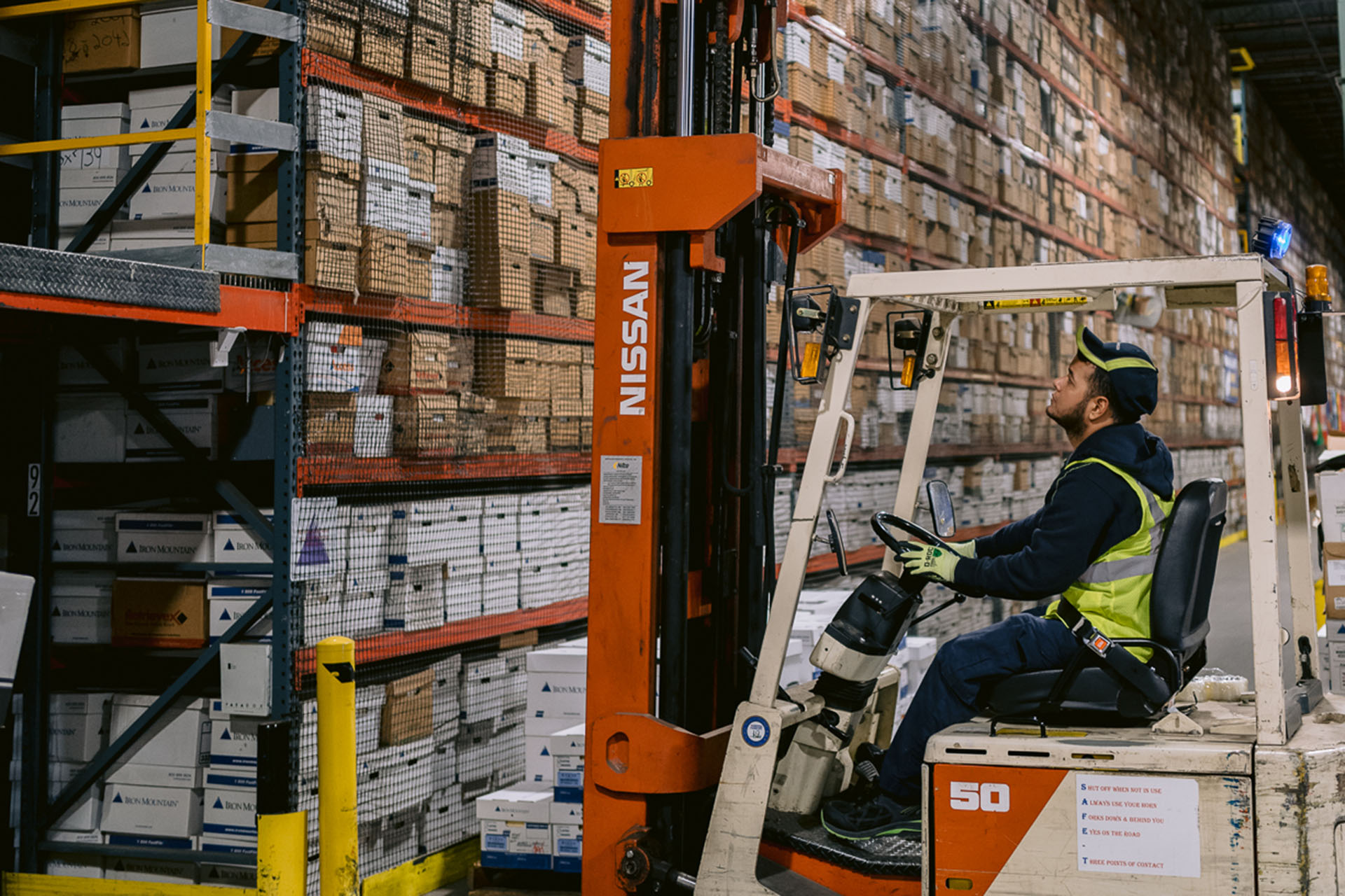 IM employee operating forklift in warehouse
