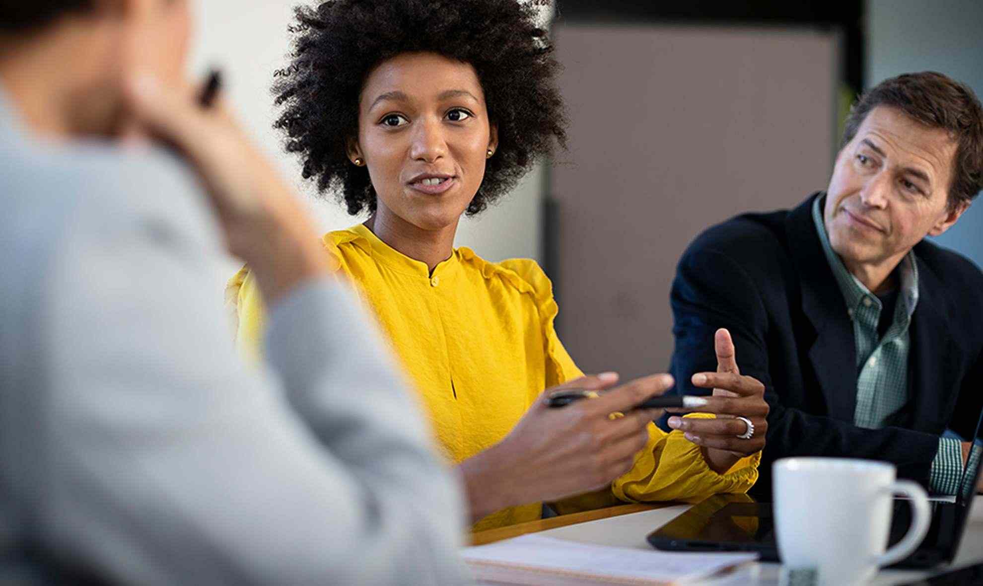 woman presents ideas with other members