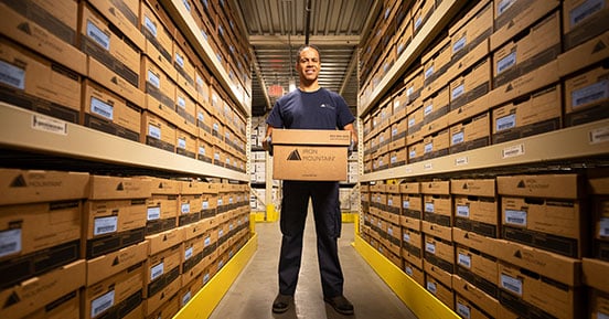 Iron Mountain Smart Sort Clears The Way For A Corporate Divestiture - IM employee in file room