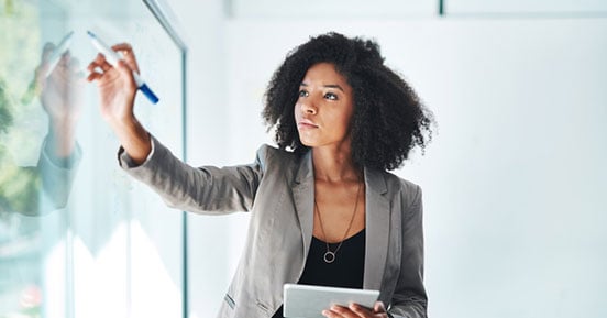 Sirius Computer Solutions- A woman writing on a whiteboard
