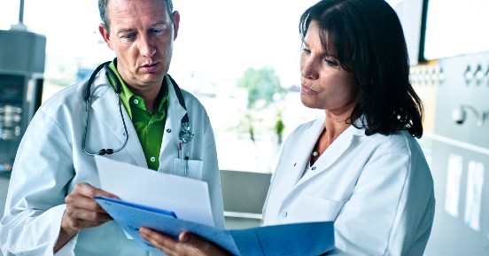 Transform Your Access to Patient Data - Doctor and nurse are watching the patient file