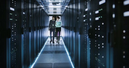 Two people talking and discussing in rack server room