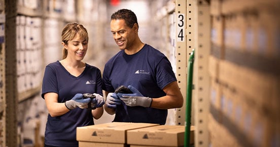 Records management how it works  - iron mountain employee pushing cart of boxes