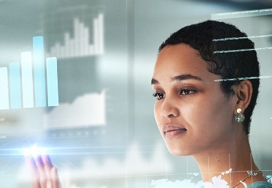 Woman touching digital screen with graphs and data
