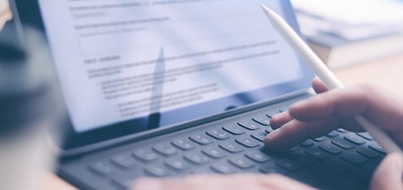 Someone is typing on a tablet PC