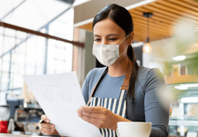 A small business owner looking at records