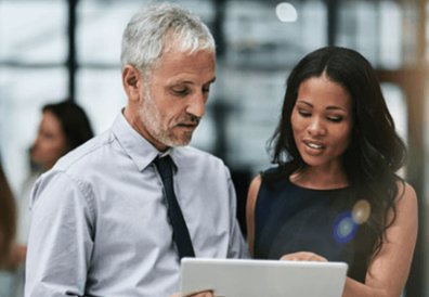 Two people engage in a discussion using digital tablet