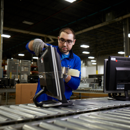IM worker packaging IT assets for destruction closeup