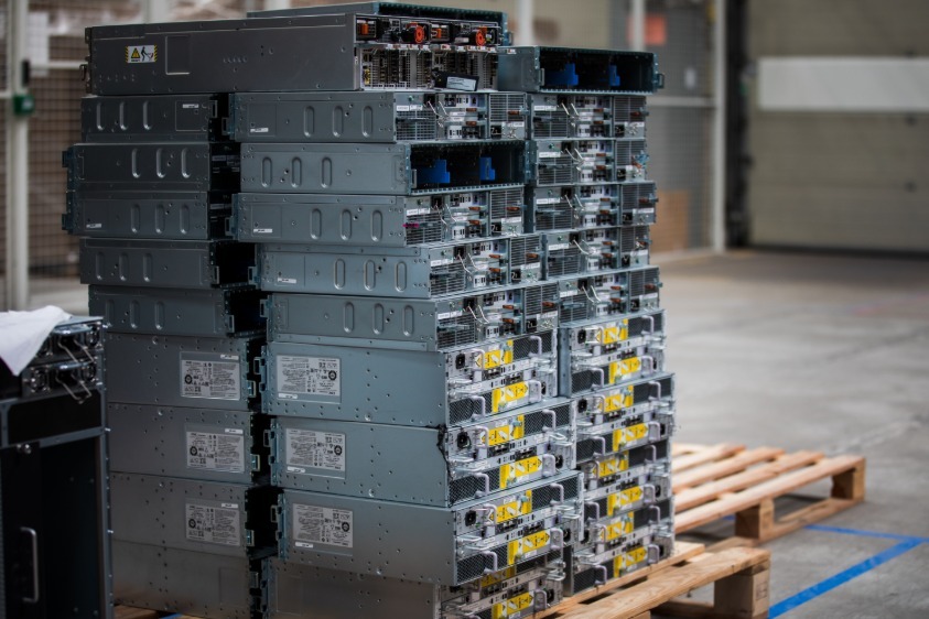 Stacks of rack-mount hardware on wooden pallets