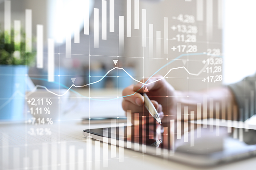 using a tablet with digital financial concept overlaid on top of image