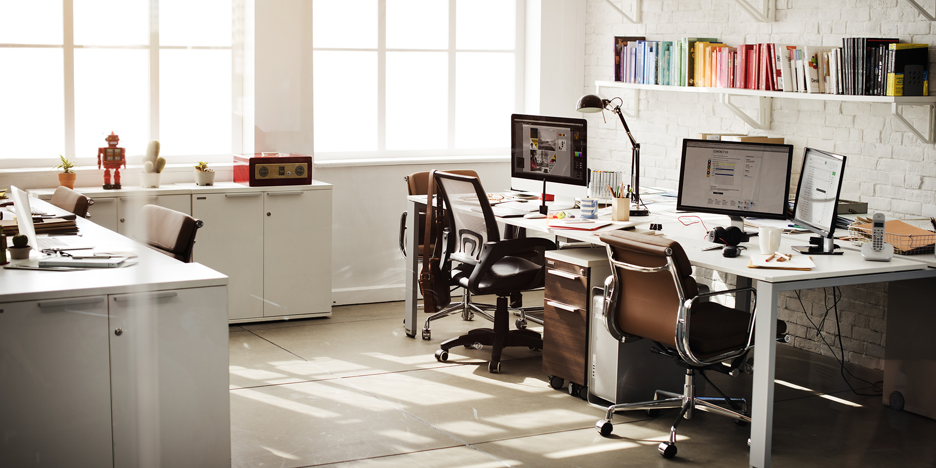 an empty minimalistic office showcasing desktop computers