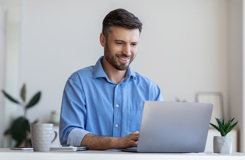 IM man with blue shirt working on the laptop