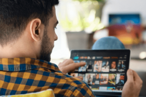 man watching movies on a tablet