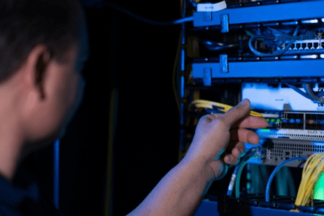 a man working on server cables