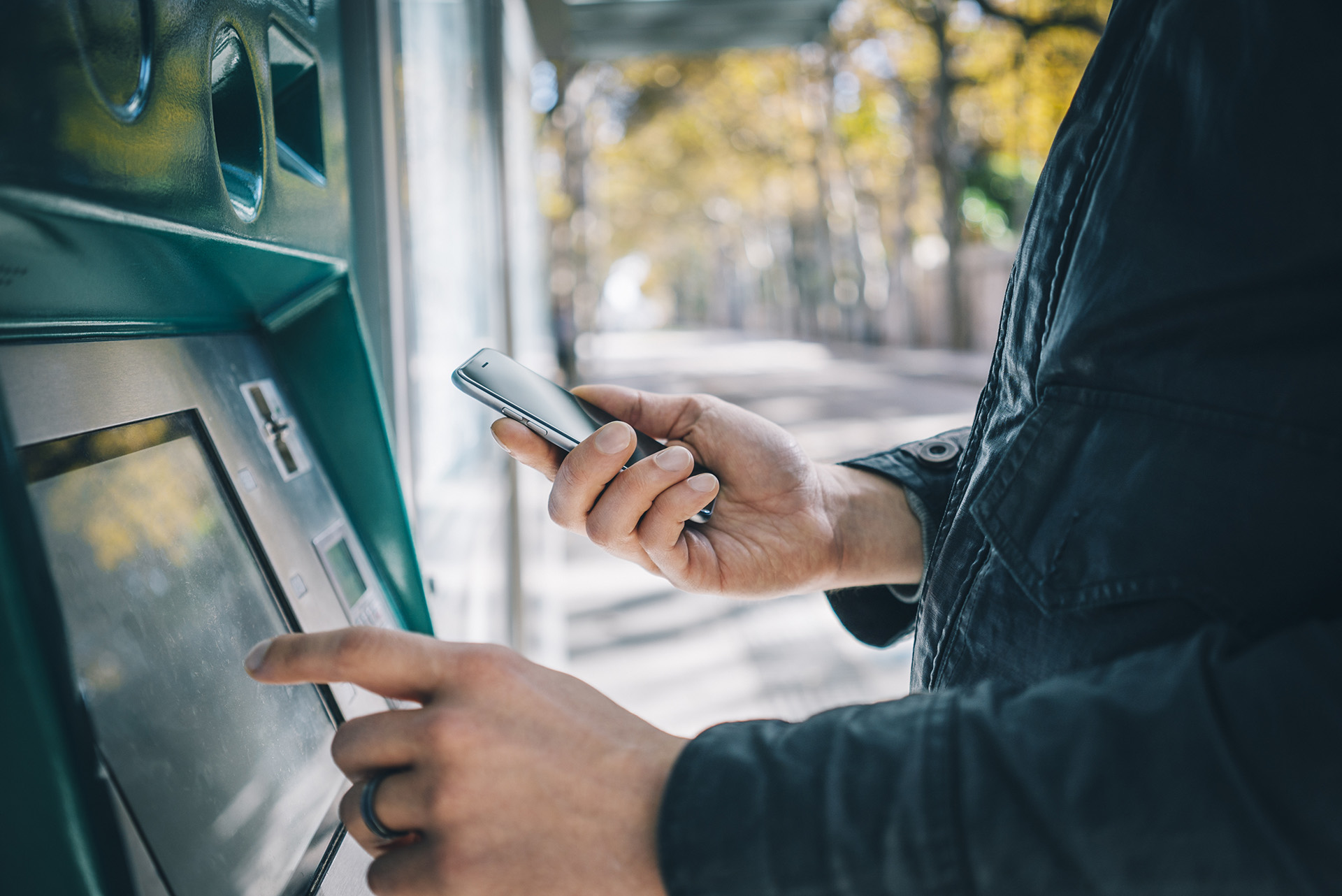 closeup of a person accessing an atm in a park