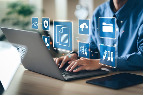 Person typing on laptop with digital file overlay