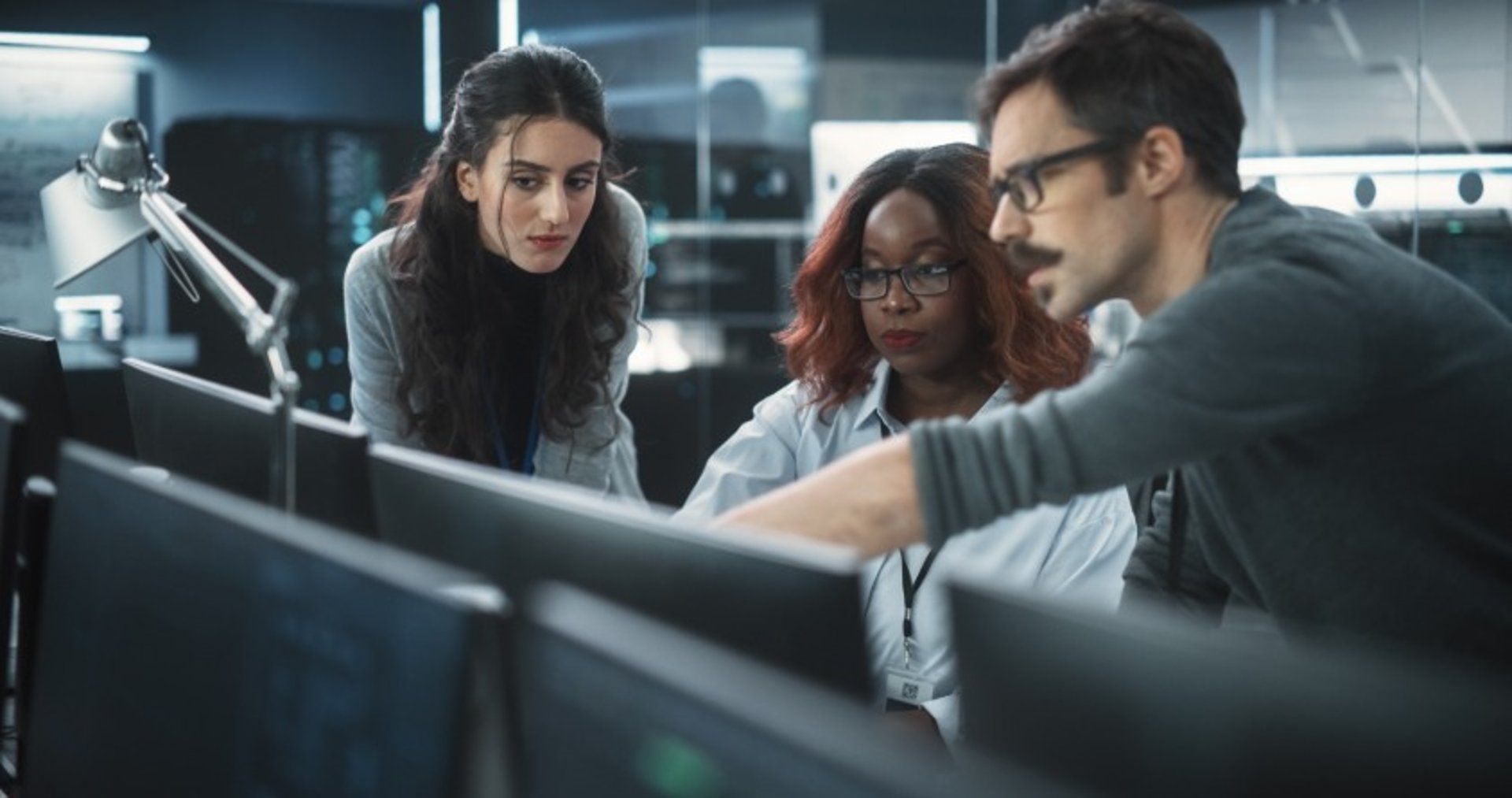 Consulting team discussing at computer