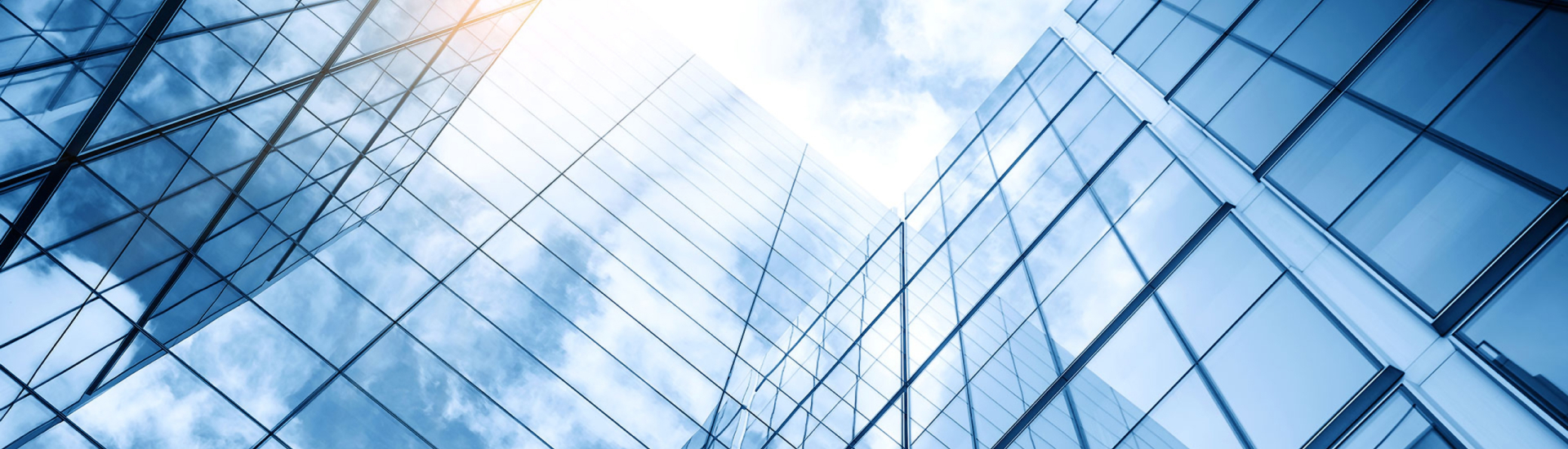 looking up at windowed skyscrapers and to the sky