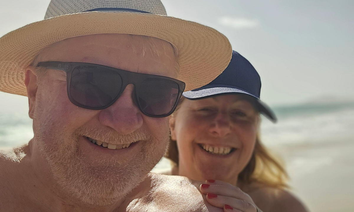 Claire and Kevin smiling on the beach