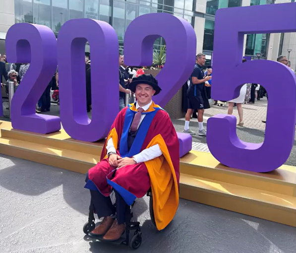 Luke in graduation robes