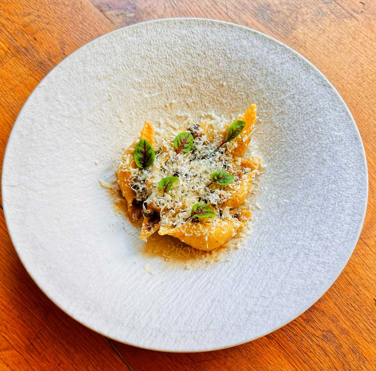 Cognilioni with green cheese and mushrooms