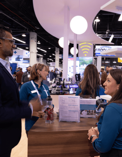 People talking at ACE 2024 in Kamstrup booth