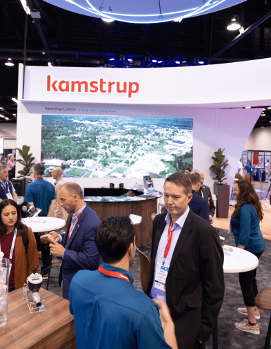 Group talking at the Kamstrup Booth at ACE 2024