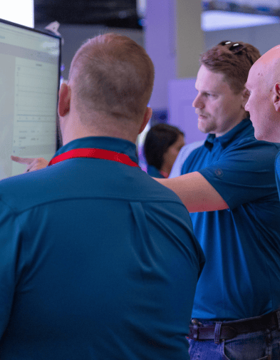 Guys presenting information at Kamstrup Booth at ACE 2024