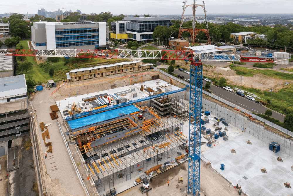 aerial view of a crane towering over a large construction site