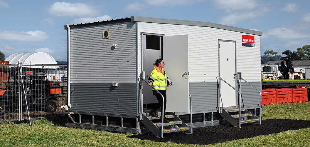 Zoomed out shot of portable toilet block situated on a construction site