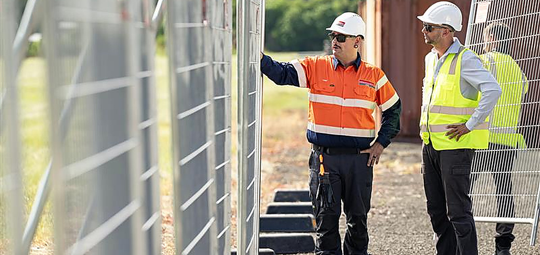 Kennards Hire Team members inspecting temporary fencing
