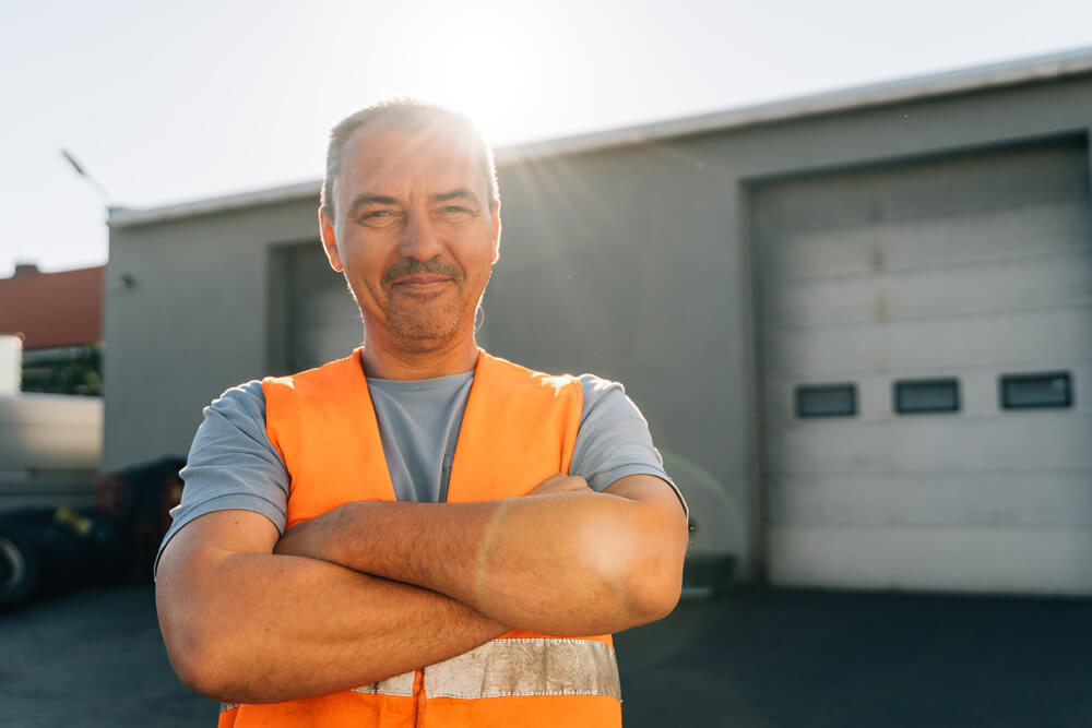 A tradesman standing with arms cross close to the camera