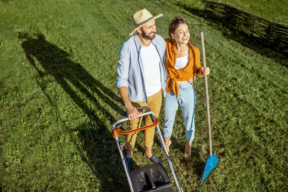 Kennards hire customers standing on green lawn after a DIY job