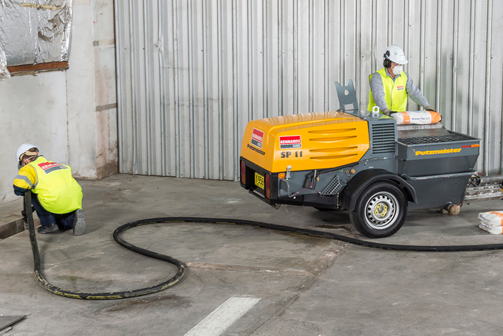 kennards hire team member using a large mixer pump  