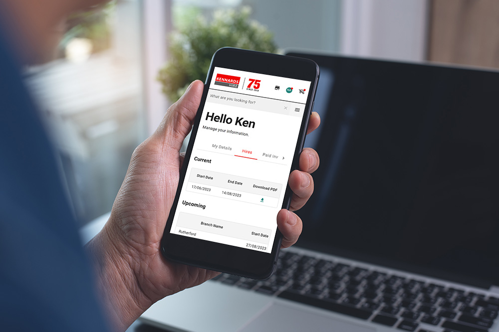 person holding a mobile phone looking at the Kennards Hire website