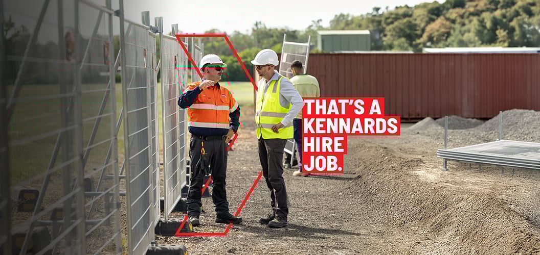 Kennards Hire experts talking to a client Infront of temporary fencing