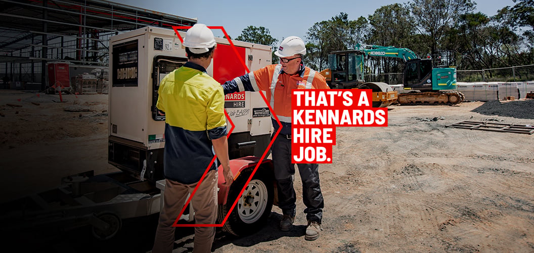 Kennards Hire expert onsite with a customer next to a generator