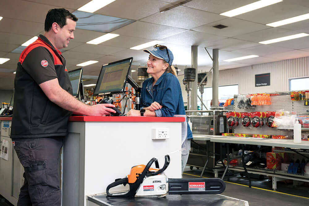 Kennards Hire team members working at a branch service desk