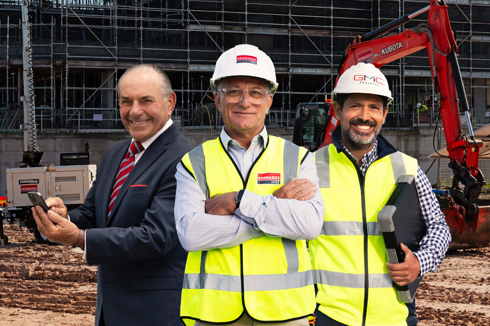 Kennards Hire team member, business man, and construction manager standing together