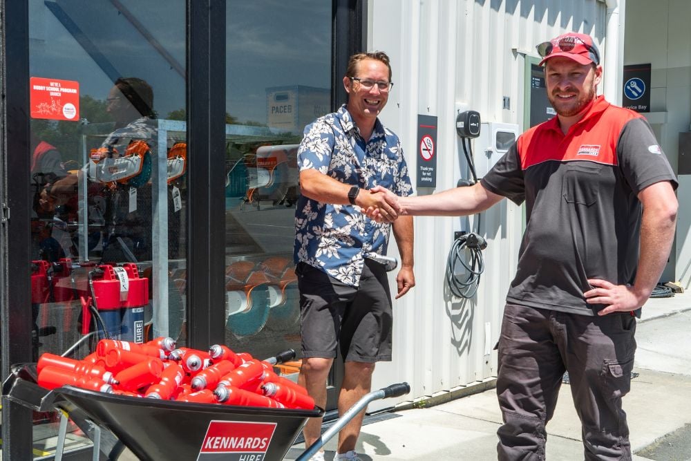 A Kennards staff member and customer shaking hands at a branch