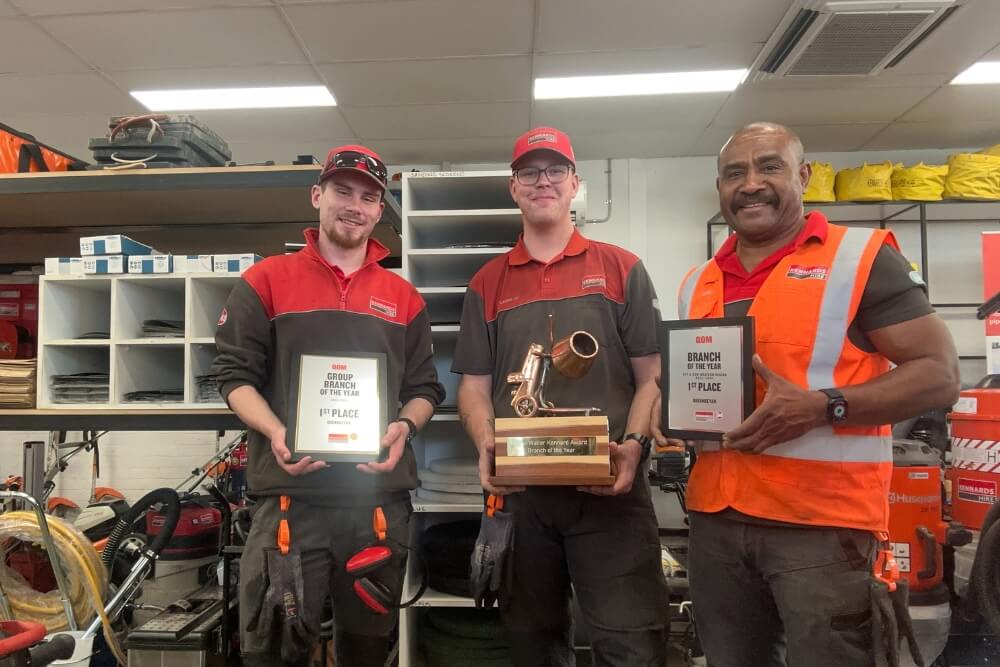 Kennards Hire Queanbeyan branch team members holding their QOM award