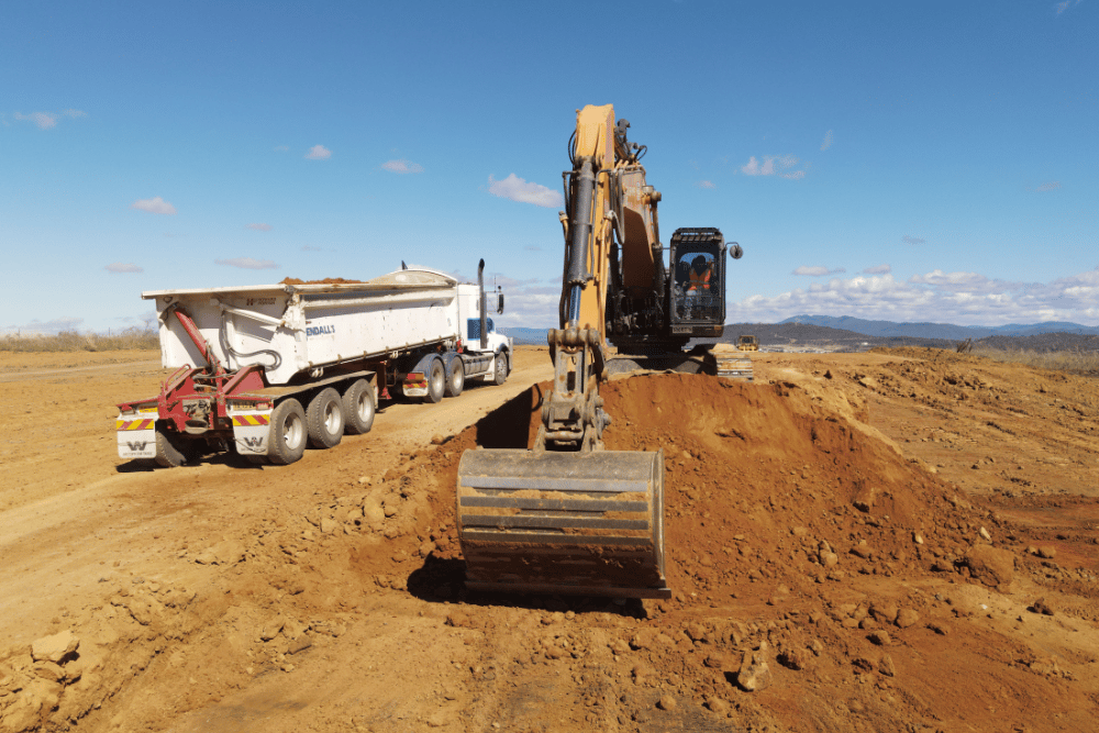 Kennards Hire excavatordigging up dirt